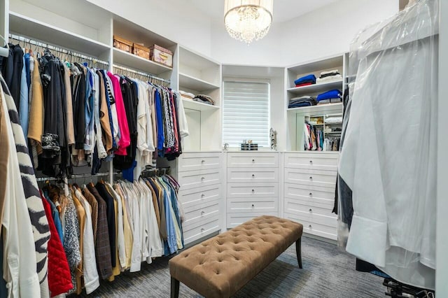 spacious closet with a chandelier