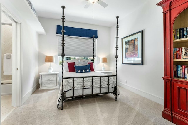 bedroom featuring light carpet and ensuite bath