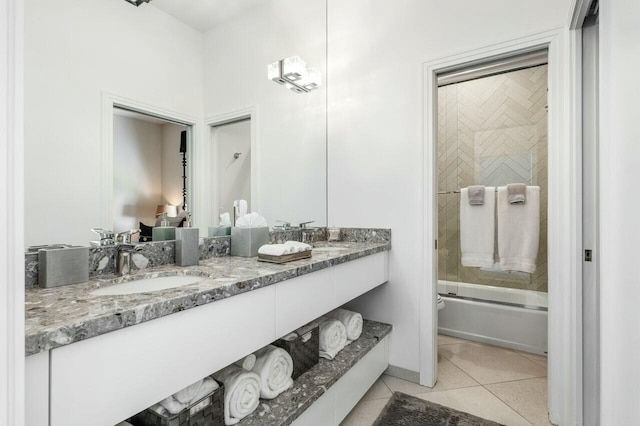 bathroom featuring tile patterned flooring, vanity, and combined bath / shower with glass door