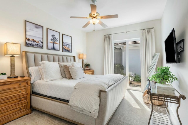 bedroom with access to outside, light colored carpet, and ceiling fan