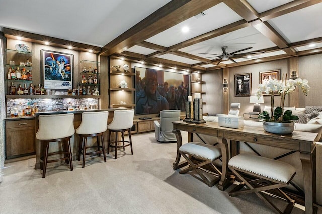 bar with ceiling fan, coffered ceiling, light colored carpet, and beam ceiling