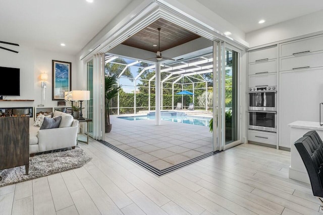 doorway to outside featuring ceiling fan and light hardwood / wood-style flooring