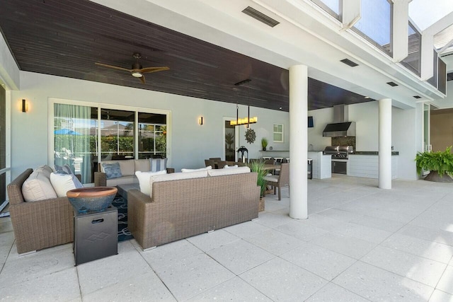 view of patio / terrace featuring area for grilling, outdoor lounge area, ceiling fan, and an outdoor kitchen