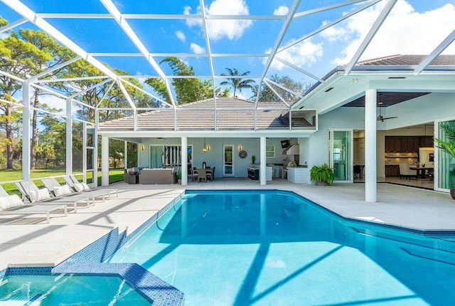 view of pool with an outdoor living space, a lanai, and ceiling fan