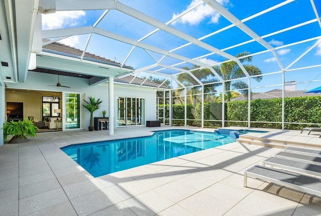 view of pool featuring a patio, ceiling fan, and glass enclosure