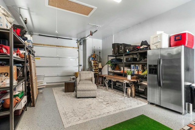 garage featuring stainless steel fridge with ice dispenser