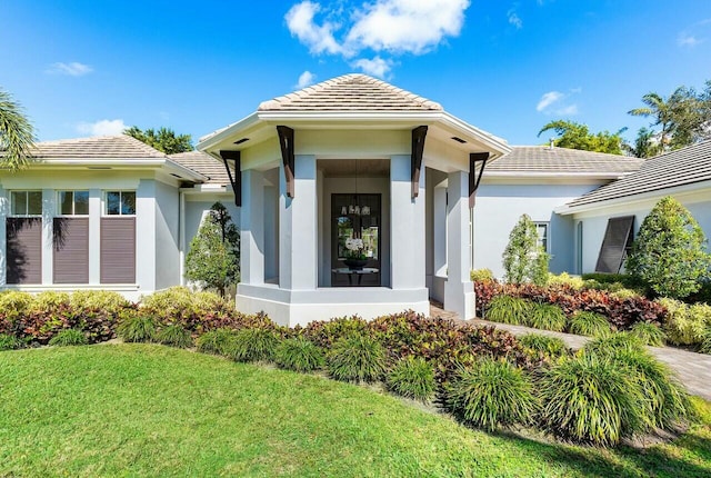 entrance to property featuring a yard