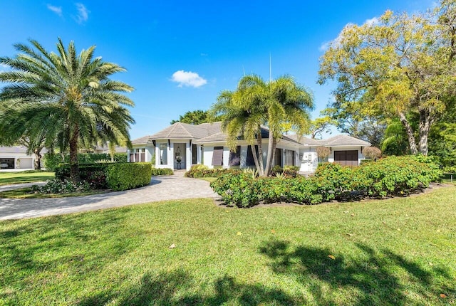 ranch-style home with a front lawn