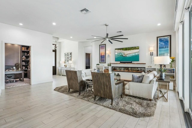 living room featuring ceiling fan and light wood-type flooring