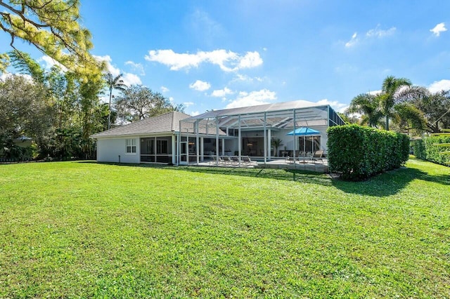 back of property featuring a yard, a lanai, and a patio