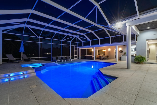 view of swimming pool with an in ground hot tub, exterior kitchen, a patio area, and glass enclosure