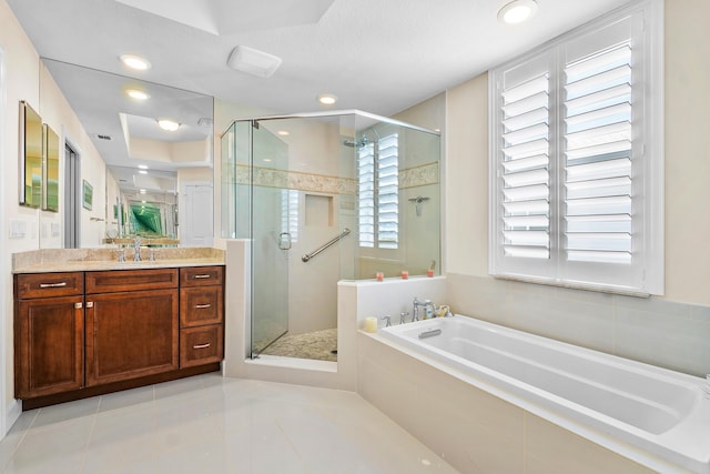 bathroom featuring independent shower and bath, vanity, and tile patterned flooring