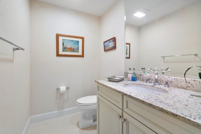 bathroom with tile patterned flooring, vanity, and toilet