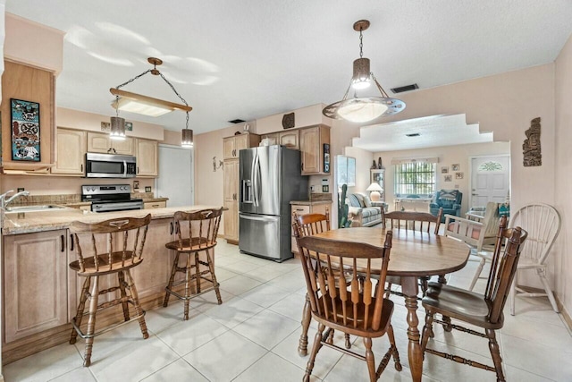 tiled dining area with sink