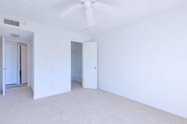 unfurnished room with ceiling fan and light colored carpet