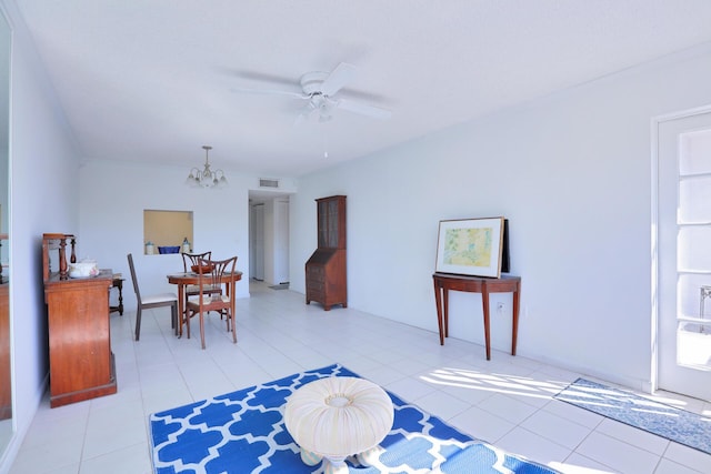 interior space featuring ceiling fan with notable chandelier