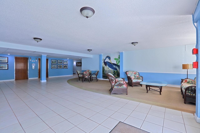 interior space with light tile patterned floors, elevator, and a textured ceiling