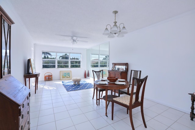 tiled dining area featuring ceiling fan with notable chandelier and a textured ceiling