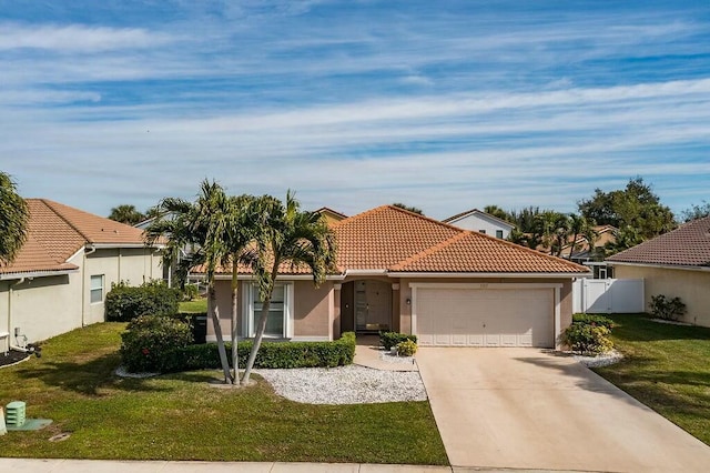 view of front of house featuring a garage and a front lawn