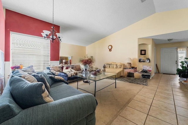 tiled living room featuring an inviting chandelier and vaulted ceiling