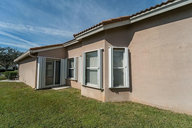 view of side of property with a yard