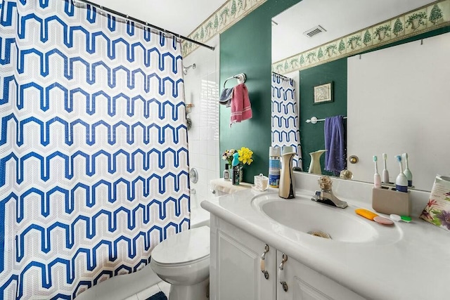 bathroom with vanity, toilet, and curtained shower