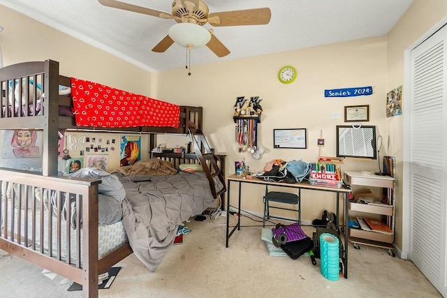 bedroom featuring carpet, ceiling fan, and a closet