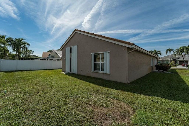 view of home's exterior with a lawn