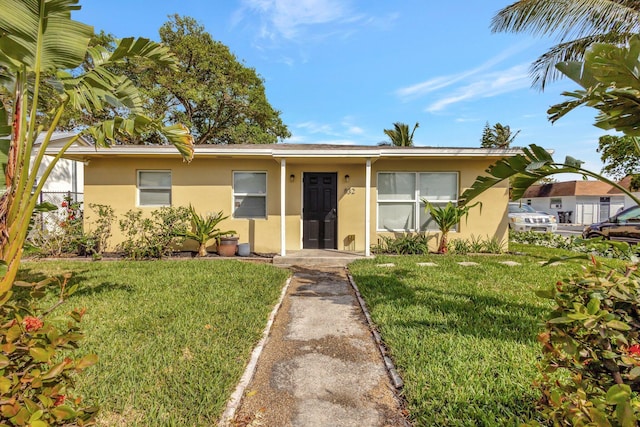 view of front of property with a front lawn and stucco siding