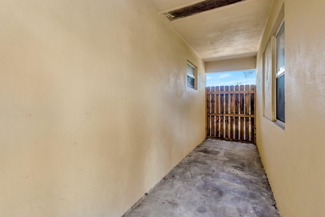 corridor with unfinished concrete flooring