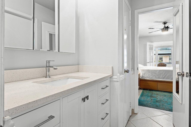 bathroom with ceiling fan, tile patterned floors, and vanity