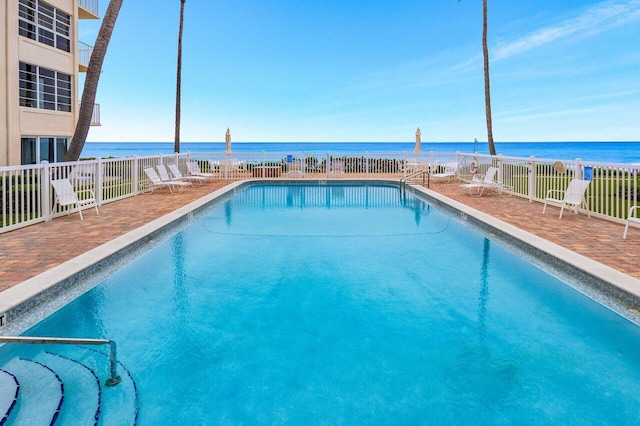 view of swimming pool featuring a water view