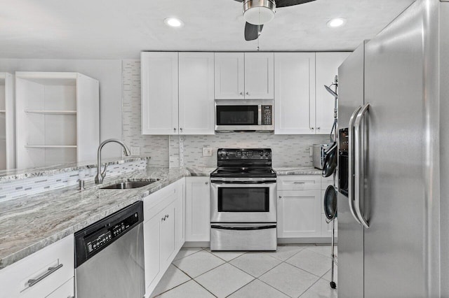 kitchen featuring white cabinetry, stainless steel appliances, sink, and decorative backsplash