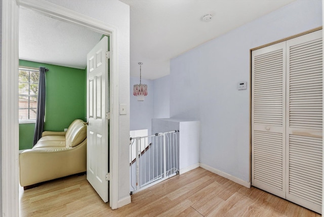 bedroom featuring a textured ceiling, a closet, and light hardwood / wood-style flooring