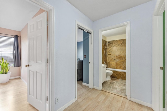 hallway with light hardwood / wood-style floors