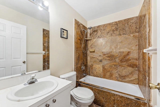 full bathroom with vanity, tiled shower / bath, and toilet