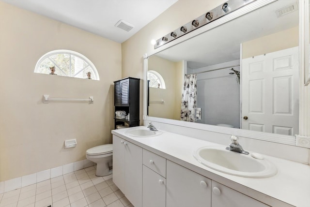 bathroom featuring tile patterned flooring, walk in shower, toilet, and a healthy amount of sunlight