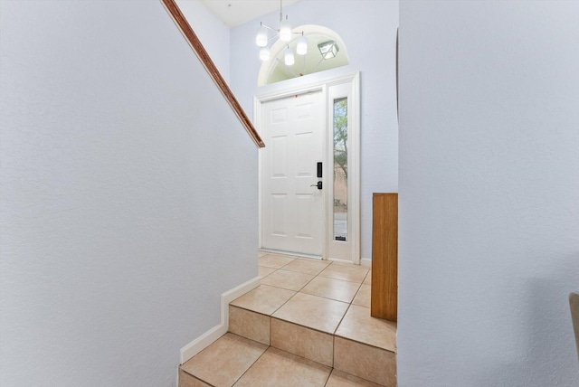 foyer featuring an inviting chandelier and light tile patterned floors