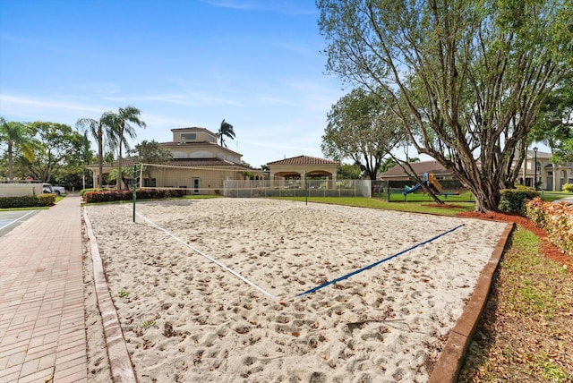 surrounding community featuring a playground and volleyball court