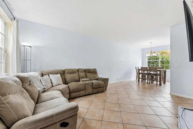 tiled living room featuring a chandelier