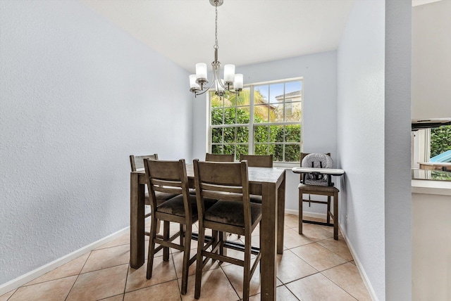 dining room with an inviting chandelier and light tile patterned floors