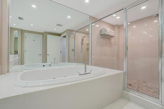 bathroom featuring tile patterned flooring and shower with separate bathtub