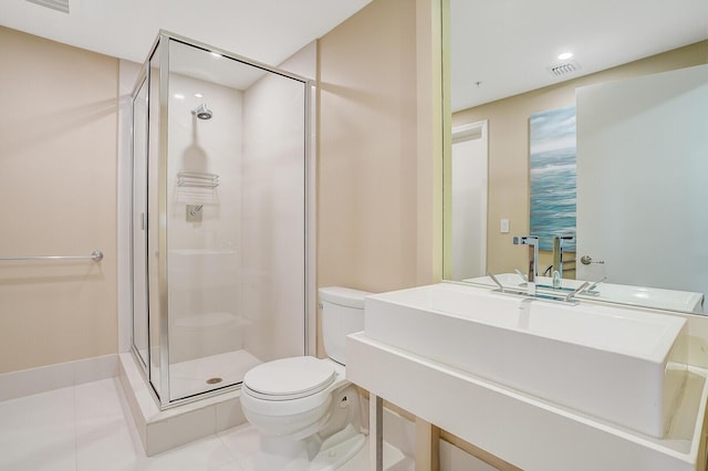 bathroom featuring tile patterned flooring, a shower with door, and toilet