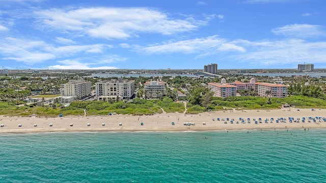 birds eye view of property featuring a beach view and a water view