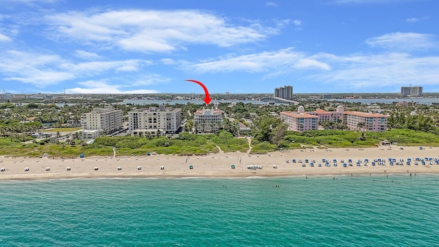 birds eye view of property with a water view and a view of the beach