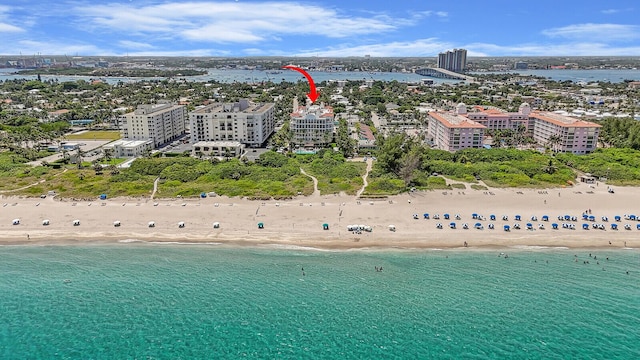 aerial view featuring a view of the beach and a water view