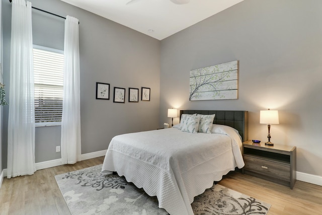 bedroom featuring baseboards and light wood-style floors