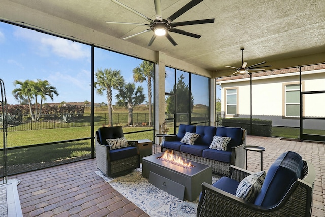 sunroom featuring ceiling fan