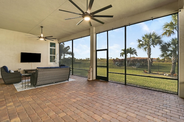 sunroom / solarium with a ceiling fan