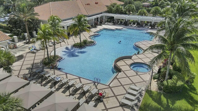 pool featuring a patio and a hot tub